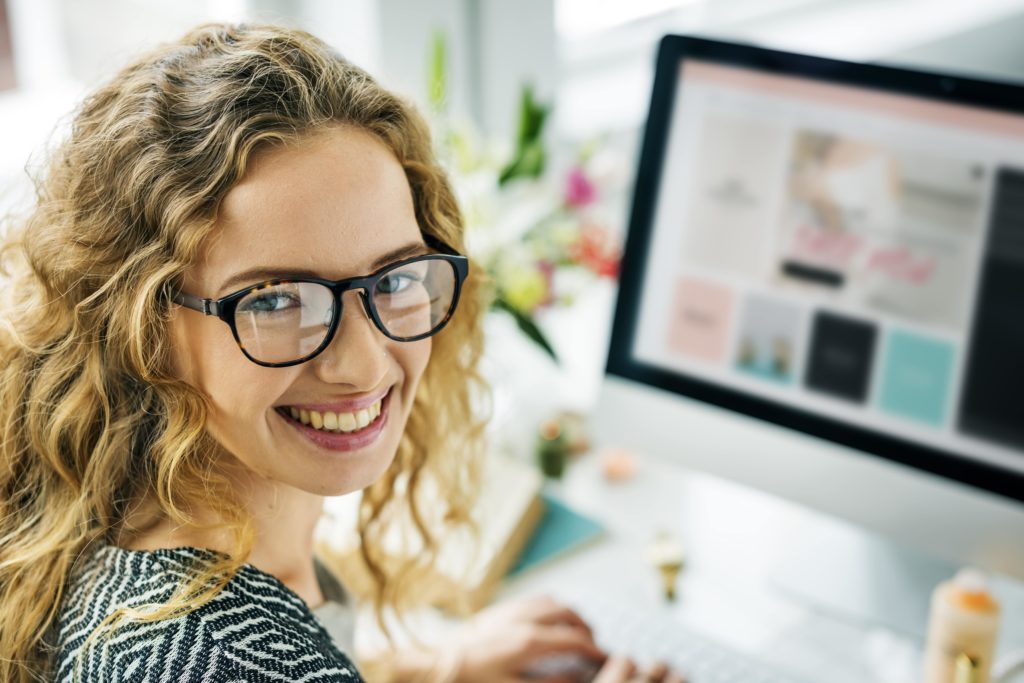 smiling woman at a computer